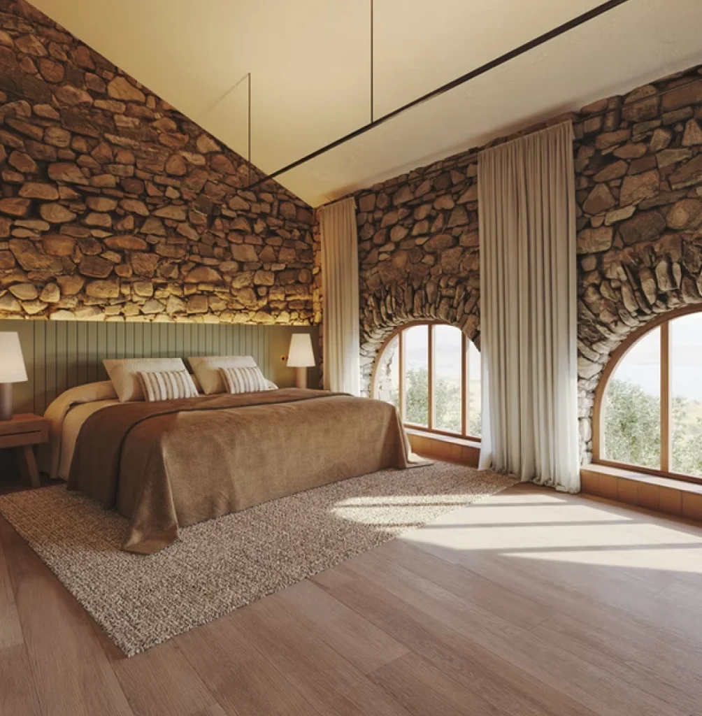 HOME Dormitorio con cabecero a medida integrado en un interior de piedra y madera